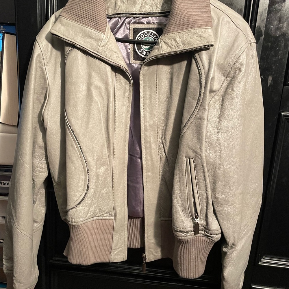 Beige leather jacket.